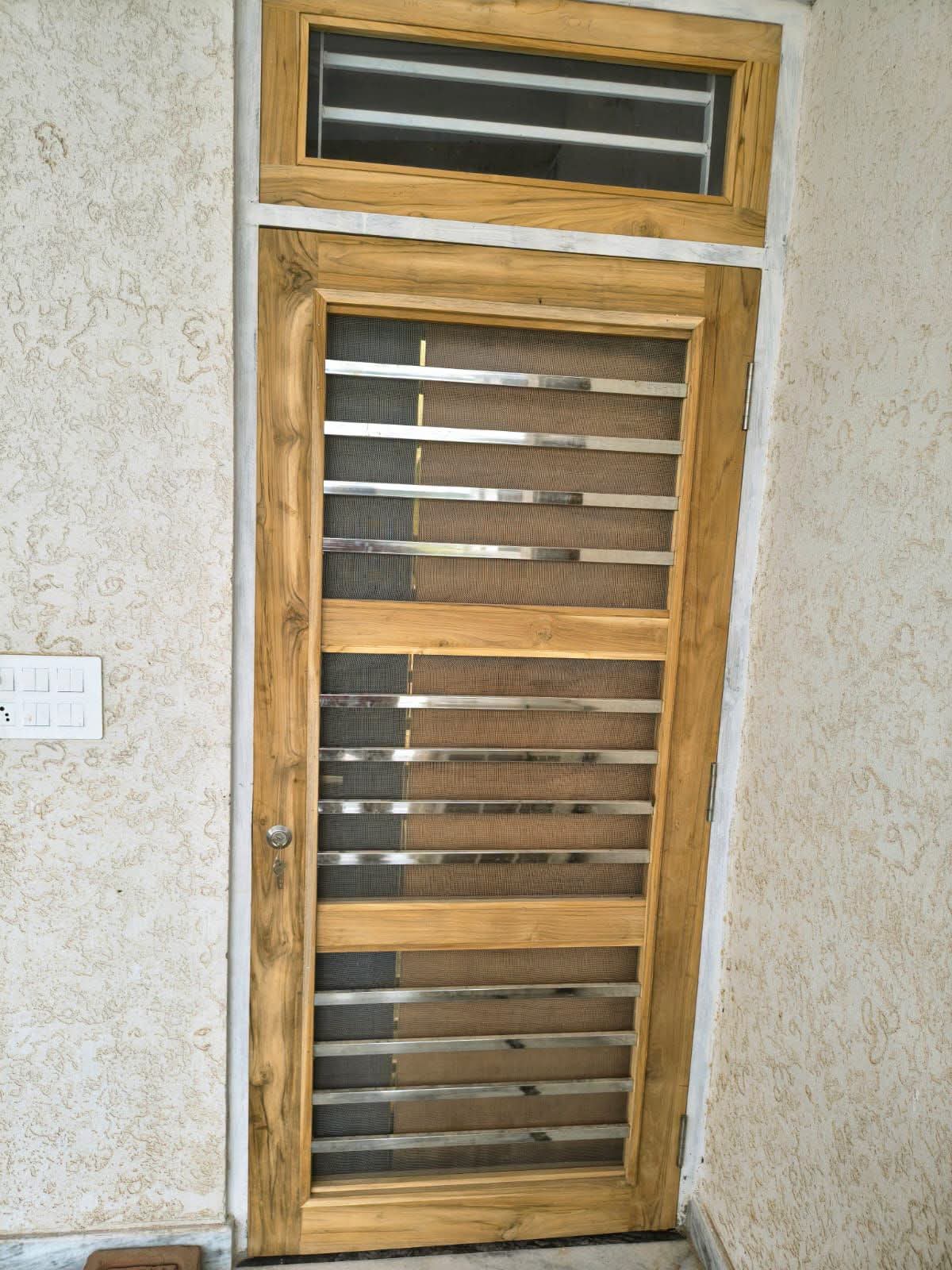 Wood-finish uPVC door with mesh ventilation panels